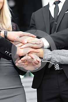 Business people folding their hands together.concept of teamwork