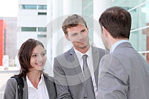 Business people gathering in front og building