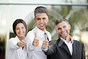 Business people giving thumbs up. Business Team