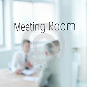 Business people, glass and meeting room sign for boardroom planning, collaboration or teamwork. Group, blurry or