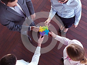 Business people group assembling jigsaw puzzle