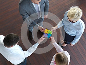 Business people group assembling jigsaw puzzle