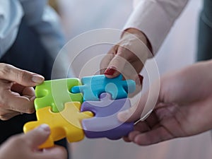 Business people group assembling jigsaw puzzle