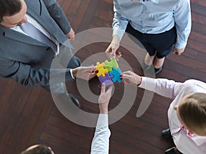 Business people group assembling jigsaw puzzle