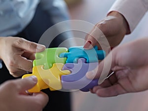 Business people group assembling jigsaw puzzle