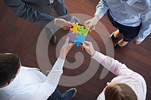 Business people group assembling jigsaw puzzle