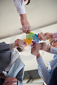 Business people group assembling jigsaw puzzle