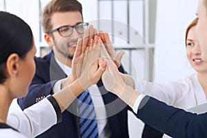 Business people group Business people group happy showing teamwork and joining hands or giving five after signing