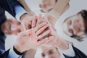 Business people group joining hands and representing concept of friendship and teamwork