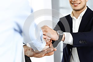 Business people group showing teamwork and joining hands as a circle in modern office. Success concept