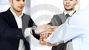 Business people group showing teamwork and joining hands as a circle in modern office. Success concept