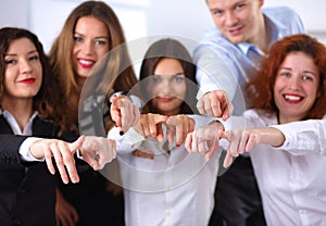 Business people group team point finger at you