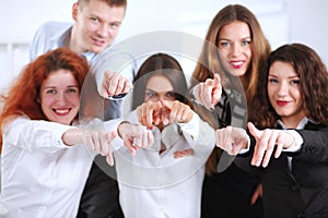 Business people group team point finger at you, in office. Business people