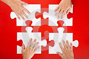 Business people hand assembling jigsaw puzzle and represent team support