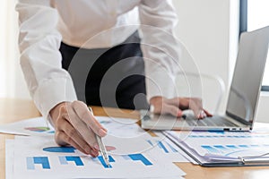 Business people hand working and calculating about graph chart finance with document report on desk