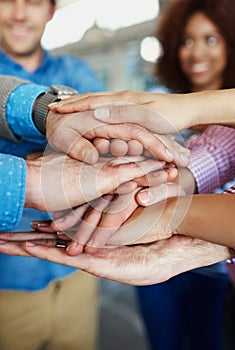 Business people hands stacked showing unity, teamwork and collaboration gesture for meeting a goal. Group closeup of