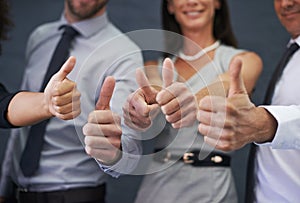 Business people, hands and thumbs up in studio for success, winning and achievement or thank you emoji. Professional