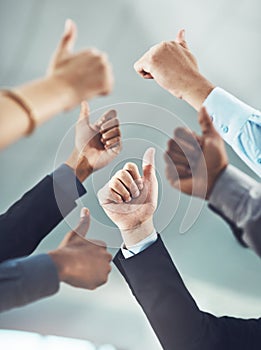 Business people, hands and thumbs up in teamwork for winning, success or company goals at office. Hand of employee group