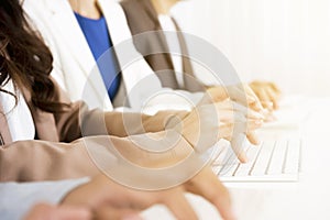 Business people hands typing on computer keyboards