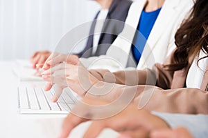 Business people hands typing on computer keyboards