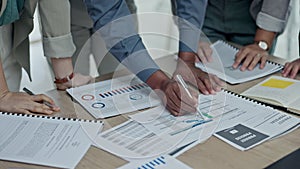 Business people, hands and writing on documents in meeting, planning or marketing strategy on office desk. Group working