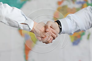 Business people handshake on background of world map of world