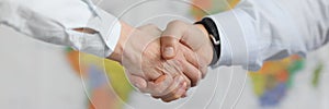 Business people handshake on background of world map of world