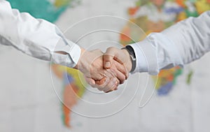 Business people handshake on background of world map of world