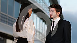 Business People Handshake - business people shaking hands. Handshake between man and woman outdoors by business building