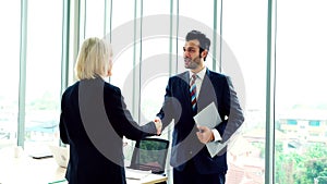 Business people handshake with friend at office