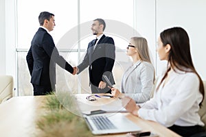 Business people handshake get agree sign of contract in meeting room