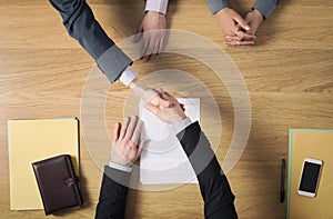 Business people handshaking after signing an agreement