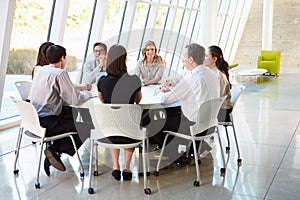 Business People Having Board Meeting In Modern Office