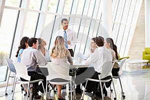 Business People Having Board Meeting In Modern Office