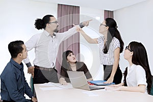 Business people having a conflict in the office