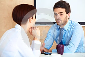 Business People having conversation with colleague during break