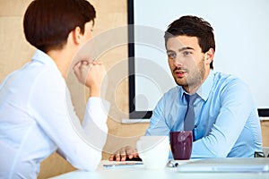 Business People having conversation with colleague during break