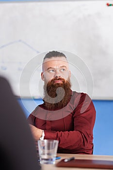 Business people having a creative meeting in an office. Businessman sitting at table