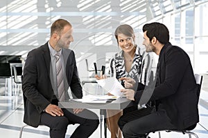 Business people having discussion by coffee table