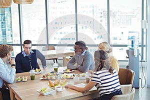 Business people having lunch at office cafeteria