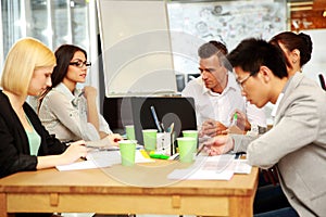 Business people having meeting around table