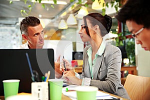 Business people having meeting around table