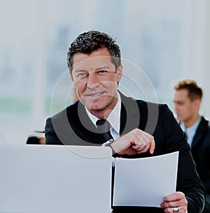 Business people having meeting around table in modern office.