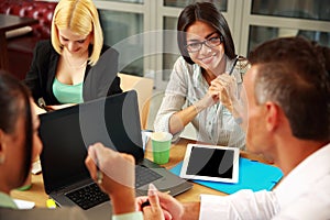 Business people having meeting around table