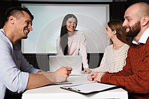 Business people having meeting in room with video projection screen