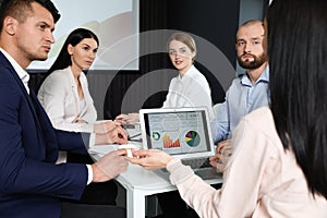 Business people having meeting in room with video projection screen