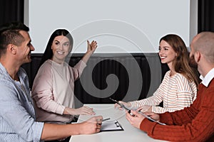 Business people having meeting in room with video projection screen