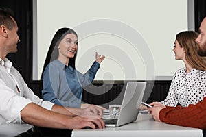 Business people having meeting in room with video projection screen