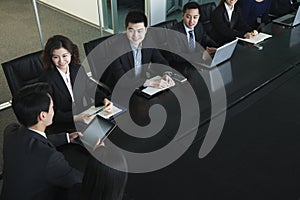 Business people having meeting, sitting at conference table