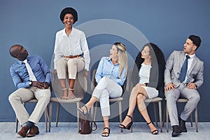 Business people, hiring and waiting room of woman standing out against wall for interview, meeting or opportunity. Group